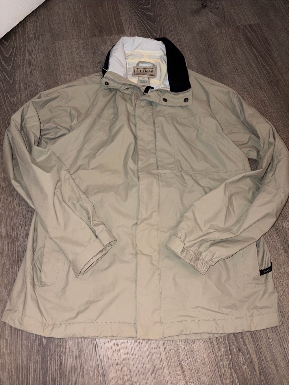 L.L.Bean Hooded beige Stowaway lightweight zip rain jacket features a storable
